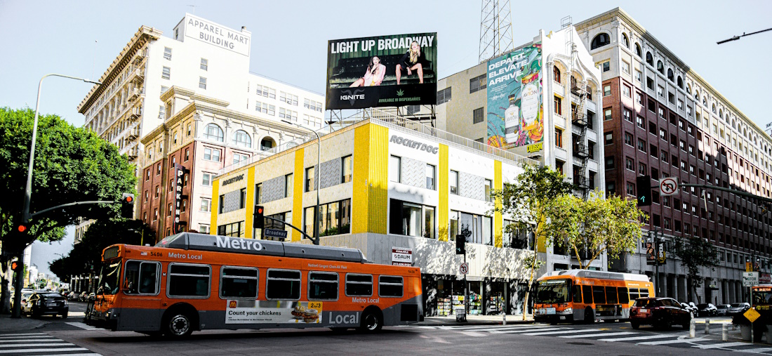 Metro buses driving on a street in Los Angeles