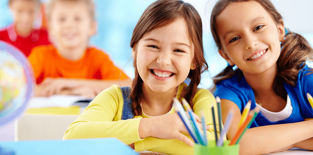 Two students smiling in the classroom