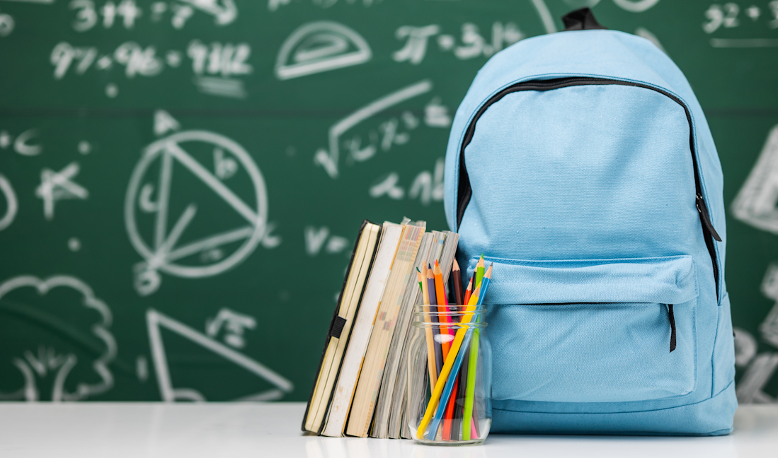 school bag and supplies in a classroom