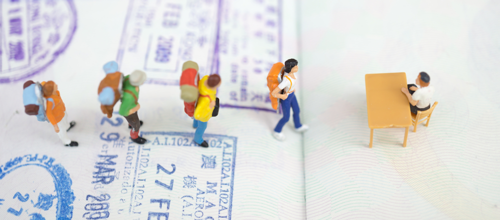 Miniatures queuing against the background of a passport